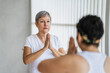 © Leonardo Borges Nuñez/Stocksy - Student receiving indications when making mudras in yoga class