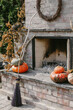 © Tana Teel/Stocksy - witch's broom stands by outdoor fireplace