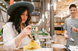 © ByLorena/Stocksy - Woman eating pasta in casual restaurant