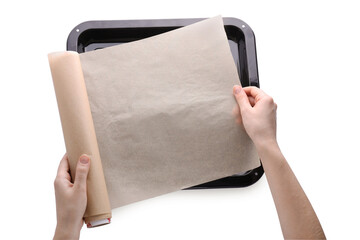 Wall Mural - Woman putting parchment paper into baking pan isolated on white, top view