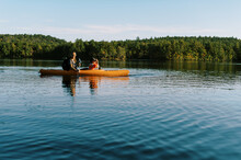 Little Boy In A Kayak With His Grandmother On A Lake 