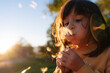 © Gemma can fly/Stocksy - Child Blowing a Dandelion at sunset