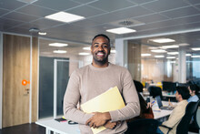 Portrait Of Smiling Young Black Man In Coworking