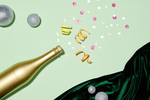 Champagne Bottle With Silver Christmas Ball  On Pastel Background.