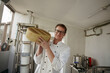 © AD Astra Team/Stocksy - A cheese maker holds cheese in his hands