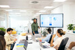 © Pedro Merino/Stocksy - Businessman making a presentation at a meeting in the office