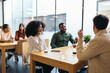 © Pedro Merino/Stocksy - Coworkers having coffee in a coworking space