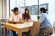 © Pedro Merino/Stocksy - Coworkers having coffee and using smartphone in coworking