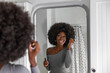 © Raymond Forbes LLC/Stocksy - Black Lifestyle Girl  bathroom mirror reflection with mascara makeup