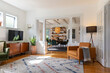 © Raymond Forbes LLC/Stocksy - Contemporary living room in home with leather chair and television