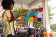 © Raymond Forbes LLC/Stocksy - African American Lifestyle Girl artist Painting with brush