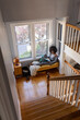 © Raymond Forbes LLC/Stocksy - black Girl relaxing at home reading book in cozy nook blanket