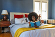 © Raymond Forbes LLC/Stocksy - African American Lifestyle Girl relaxing at home reading book