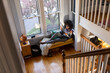 © Raymond Forbes LLC/Stocksy - Black Girl at home relaxing listens to music on bluetooth speaker
