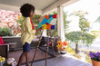 © Raymond Forbes LLC/Stocksy - African American Lifestyle Girl artist abstract  Painting easel