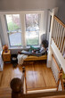 © Raymond Forbes LLC/Stocksy - black Girl at house drawing  with ipad tablet computer in cozy nook