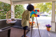 © Raymond Forbes LLC/Stocksy - African American  Girl artist Painting easel in home studio