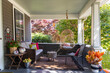 © Raymond Forbes LLC/Stocksy - Porch of house in suburban neighborhood with swing
