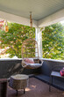 © Raymond Forbes LLC/Stocksy - Porch of home in suburban neighborhood with hanging swing