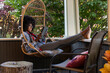 © Raymond Forbes LLC/Stocksy - African American Lifestyle Girl reads at home with tablet computer