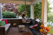 © Raymond Forbes LLC/Stocksy - Black  Lifestyle Girl relaxing outdoors porch with tablet computer