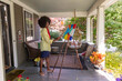 © Raymond Forbes LLC/Stocksy - Black  Lifestyle Girl artist Painting easel in home studio