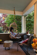 © Raymond Forbes LLC/Stocksy - Porch Lifestyle Girl relaxing at home with tablet ipad computer