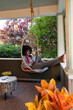 © Raymond Forbes LLC/Stocksy - Front Porch Lifestyle Girl relaxing at home with tablet computer