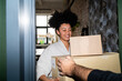 © Hernandez & Sorokina/Stocksy - Woman Receiving Parcel At Home