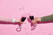 © Marc Tran/Stocksy - Celebration toast with wine with color streamers