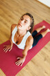 © Valentina Barreto/Stocksy - Pretty woman practicing yoga on mat