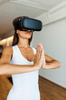 © Valentina Barreto/Stocksy - Woman practicing virtual yoga