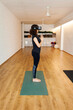 © Valentina Barreto/Stocksy - Female practicing vr yoga in studio