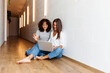 © Valentina Barreto/Stocksy - Women enjoying watching laptop on the hall floor