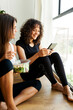 © Valentina Barreto/Stocksy - Two women during break after yoga class