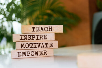 wooden blocks with words 'teach inspire motivate empower'.