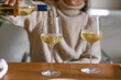 © ByLorena/Stocksy - Female serving wine glasses