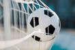 © Alexey Kuzma/Stocksy - soccer ball in the net, selective focus