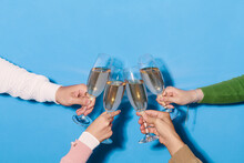 People Hold In Hands Glasses With White Champagne.