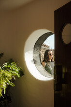 Portrait Of A Woman Behind A Round Window
