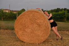 A Woman Relaxing On A Stack Of Hay
