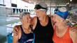 © Rob and Julia Campbell/Stocksy - Group of women laughing at the swimming pool.
