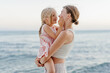© Sergey Narevskih/Stocksy - Child caress woman face near sea