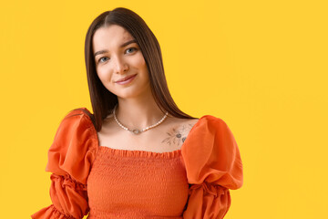 Sticker - Young woman in stylish blouse on yellow background