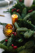 © Oleksii Syrotkin/Stocksy - Christmas candle fir twig celebrate interior decoration