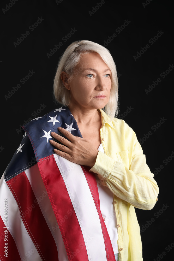Mature woman with USA flag on black background