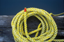 A Yellow Coiled Rope On The Dock