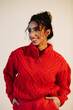 © Sergey Filimonov/Stocksy - Happy woman in red sweater - Fall fashion