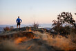 © Rob and Julia Campbell/Stocksy - Tired runner man on top of hill after summiting.