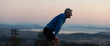 © Rob and Julia Campbell/Stocksy - Tired runner man on top of hill after summiting.